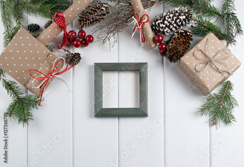 Christmas background with photo frame, spruce, gift box and scro photo