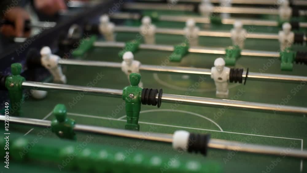 Friends having fun together playing table football. Friends having fun together playing table football.