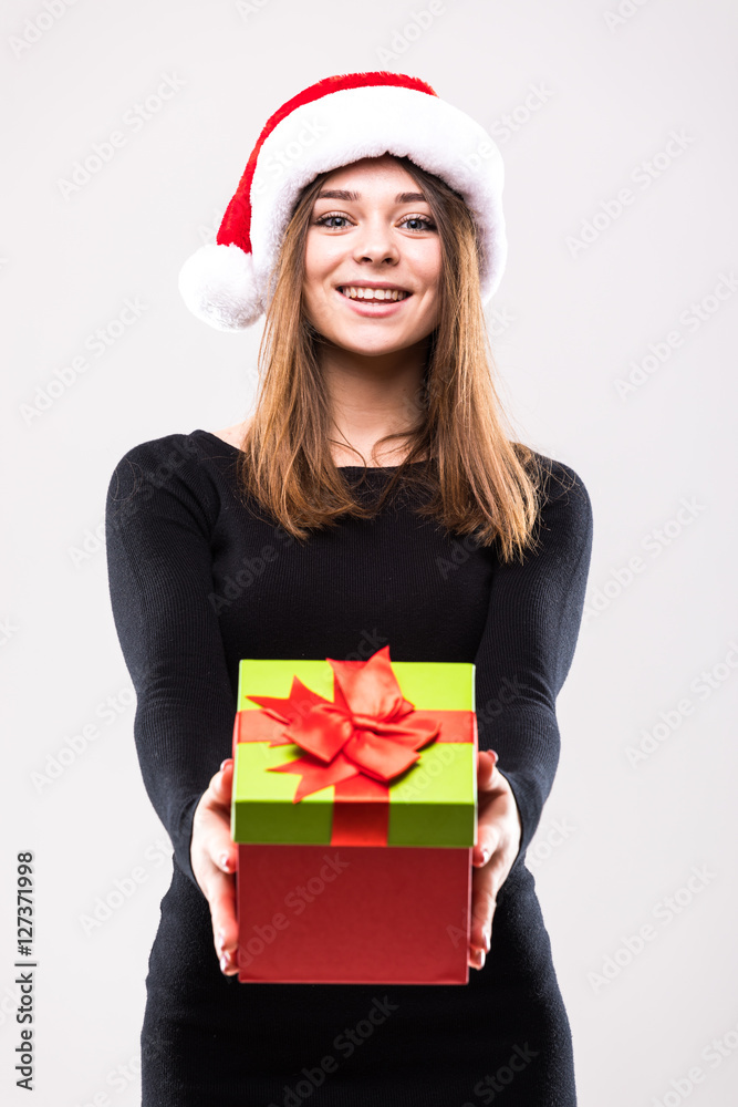 Christmas Woman with Gift Box. Beautiful Brunette Girl in Santa Hat isolated. Portrait Christmas Woman with Gift Box. Beautiful Brunette Girl in Santa Hat isolated. Portrait