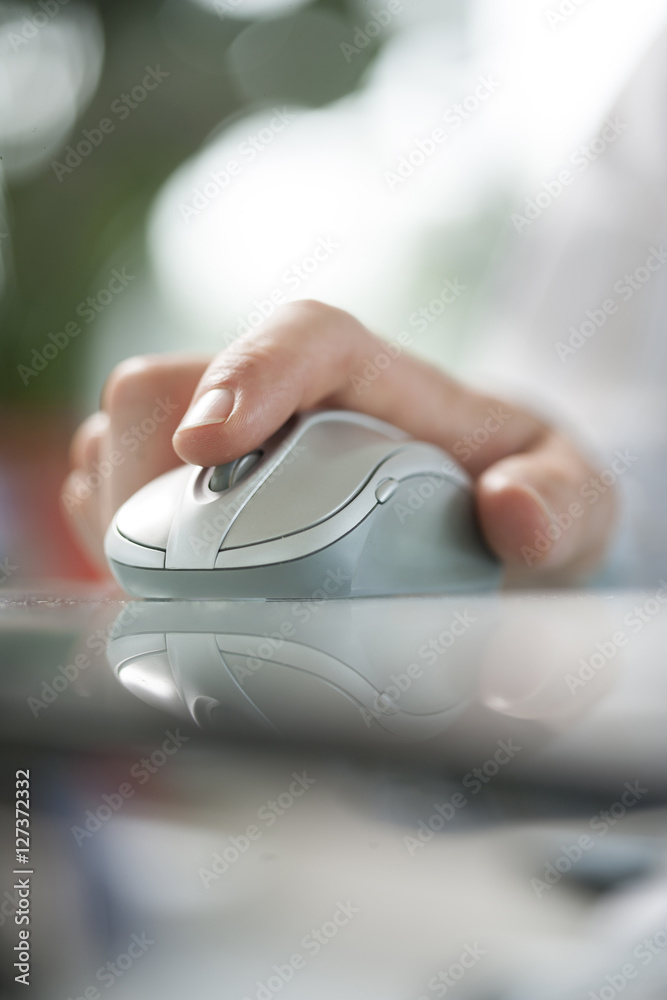man using his forefinger to control a cordless mouse man using his forefinger to control a cordless mouse