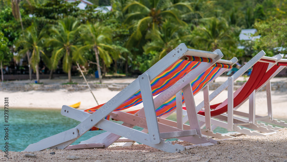 Appealing Beach Chairs on Sand. Palm Trees and Ocean in Background. Haad Salat. Koh Pangang, Thailand Appealing Beach Chairs on Sand. Palm Trees and Ocean in Background. Haad Salat. Koh Pangang, Thailand