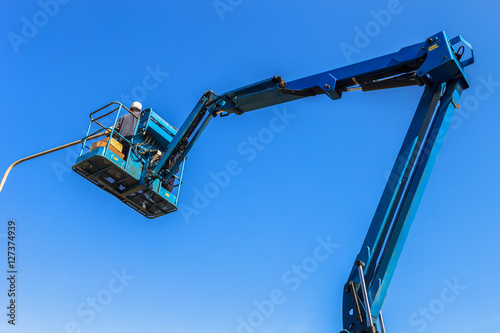 Wallpaper Mural Electrical technician repairing street light by boom lift  Torontodigital.ca