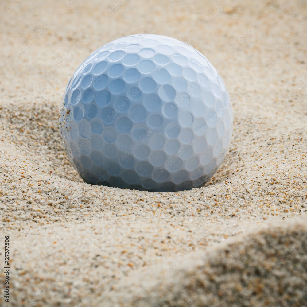 Close up golf ball in sand bunker shallow depth of field. A golf Close up golf ball in sand bunker shallow depth of field. A golf