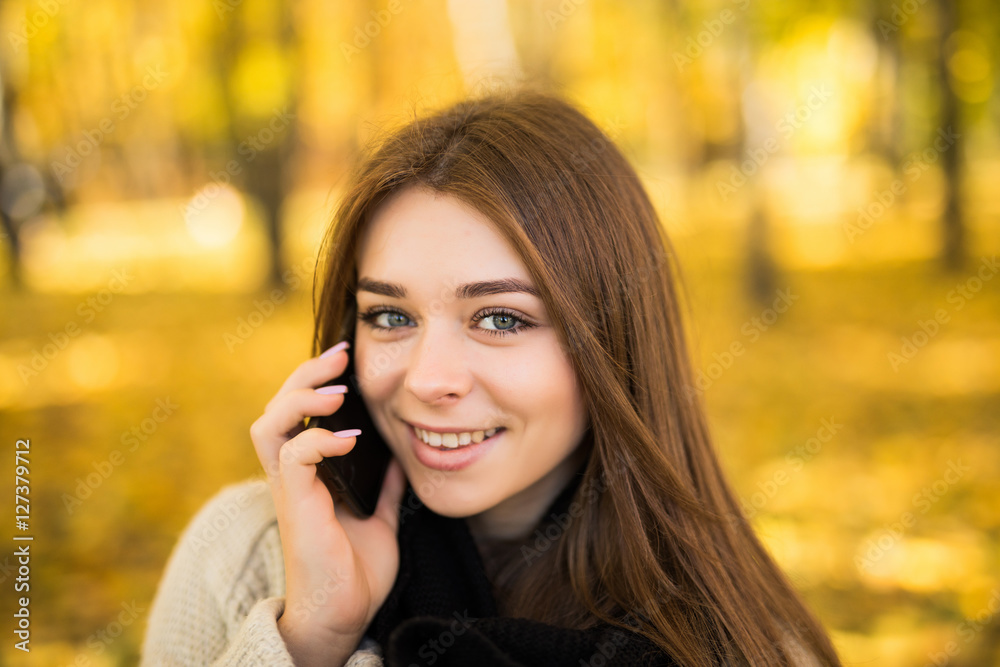 Portrait of girl speak on phone in sunny autumn park Portrait of girl speak on phone in sunny autumn park