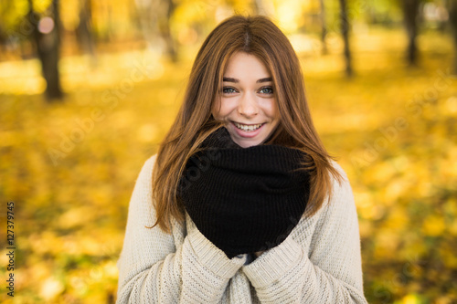 Portrait of young girl in sunny autumn park
