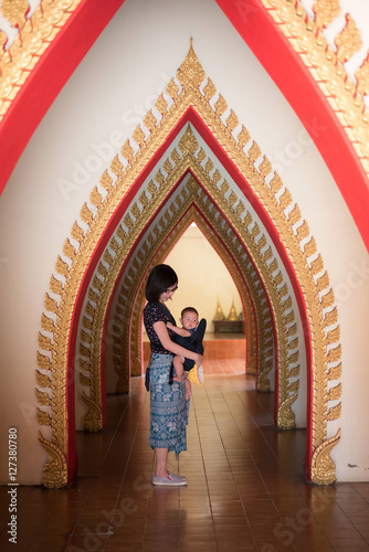 Mother holding baby in Baby Carriers,baby in thailand temple © samurai
