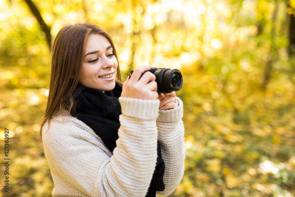 Girl take photo with camera in yellow autumn park Girl take photo with camera in yellow autumn park
