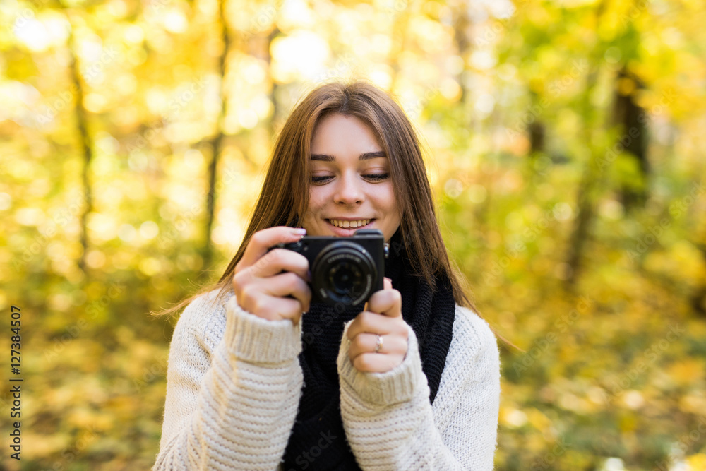 Girl take selfie photo with camera in yellow autumn park Girl take selfie photo with camera in yellow autumn park