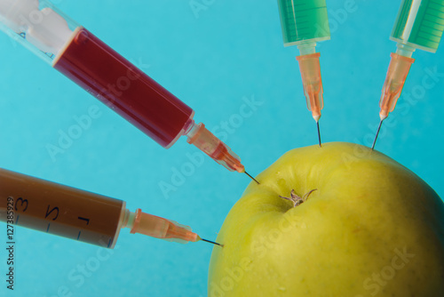 Chemical additives in food or genetically modified fruit concept