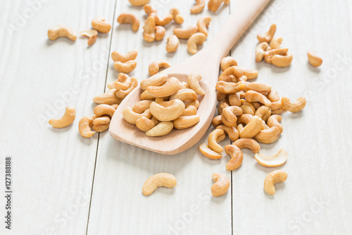 Cashew nuts on a wooden ladle