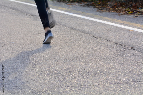 Group of runners during a race cross-country road; motion blur to highlight the speed effect