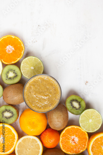 Smoothie rich in vitamin C made with oranges, lemons, limes, clementines, kiwis, top view, selective focus © Liliya Trott