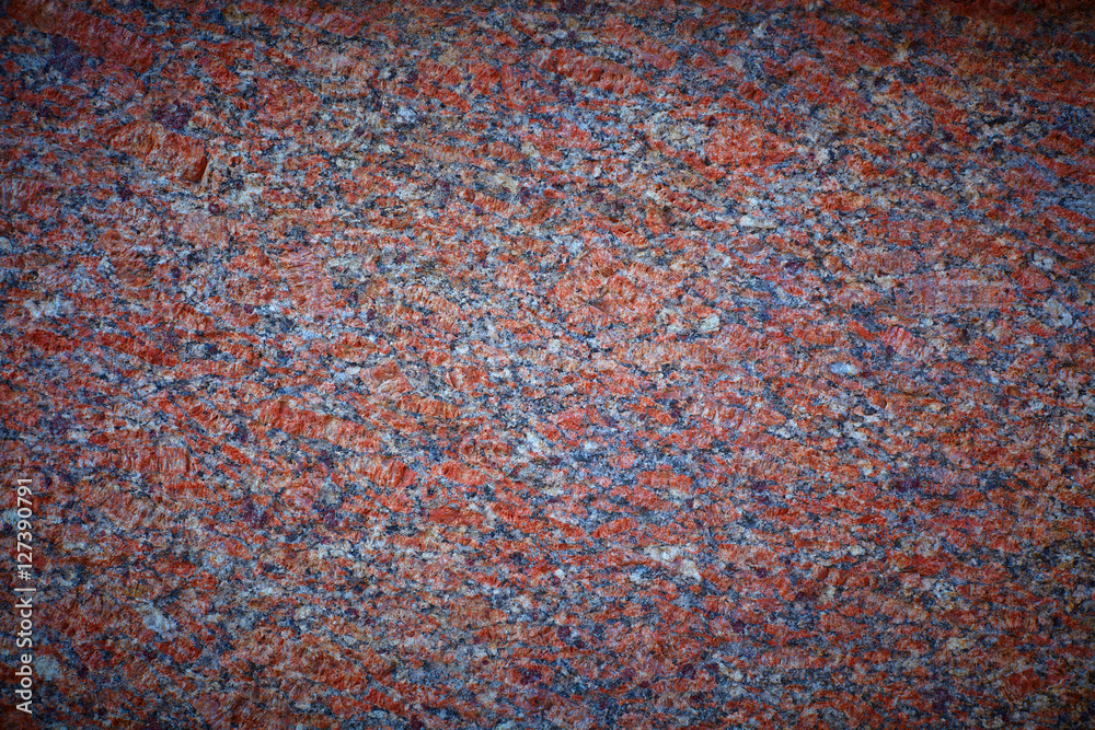 Red granite slab closeup may be used as background vignette Red granite slab closeup may be used as background vignette