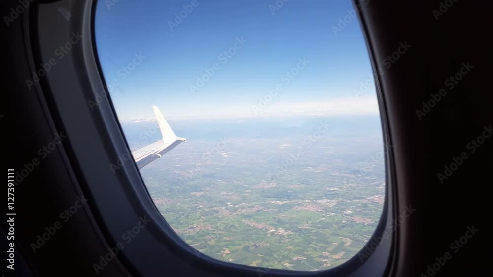 Clouds seen through the window of jet airplane.