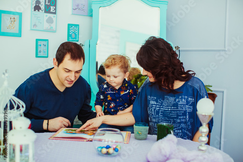 The mother,father and son reading a book