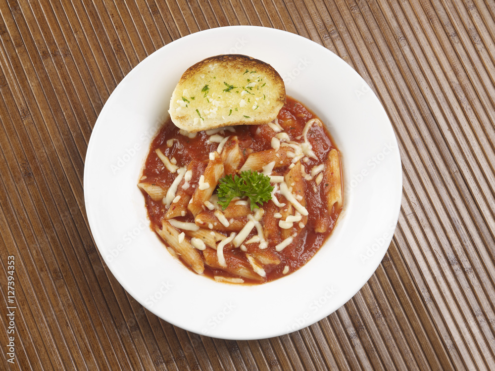 PENNE ARRABIATA SERVED IN A WHITE PLATE ON WHITE BACKGROUND PENNE ARRABIATA SERVED IN A WHITE PLATE ON WHITE BACKGROUND