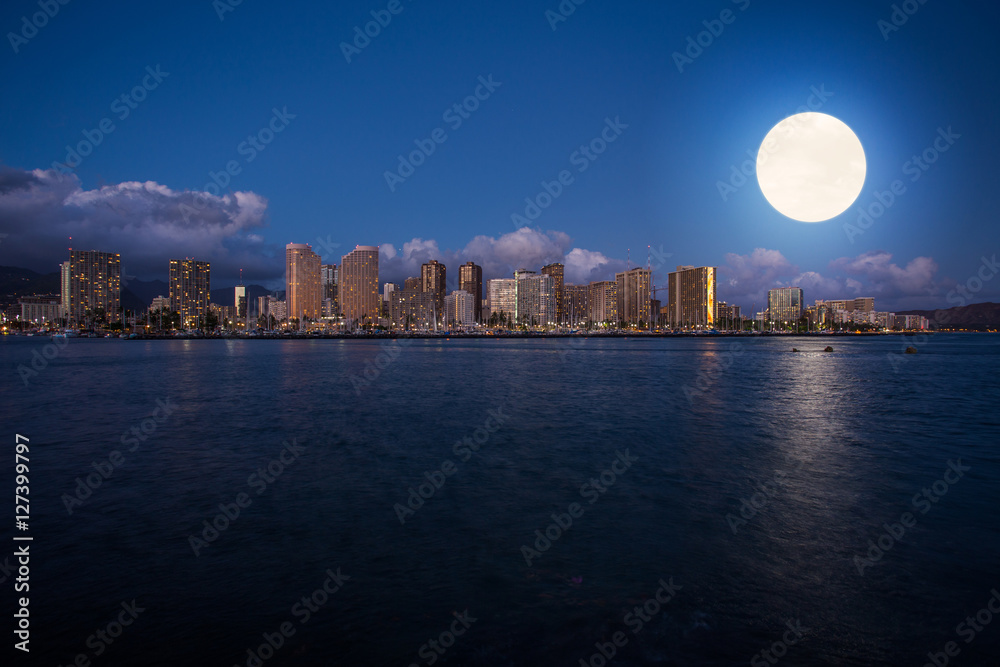 Super full moon over Honolulu downtown at night Super full moon over Honolulu downtown at night
