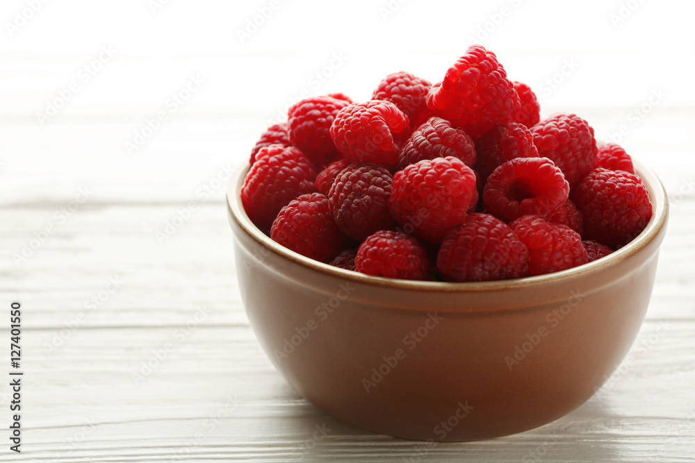 Fresh raspberries in bowl on table Fresh raspberries in bowl on table