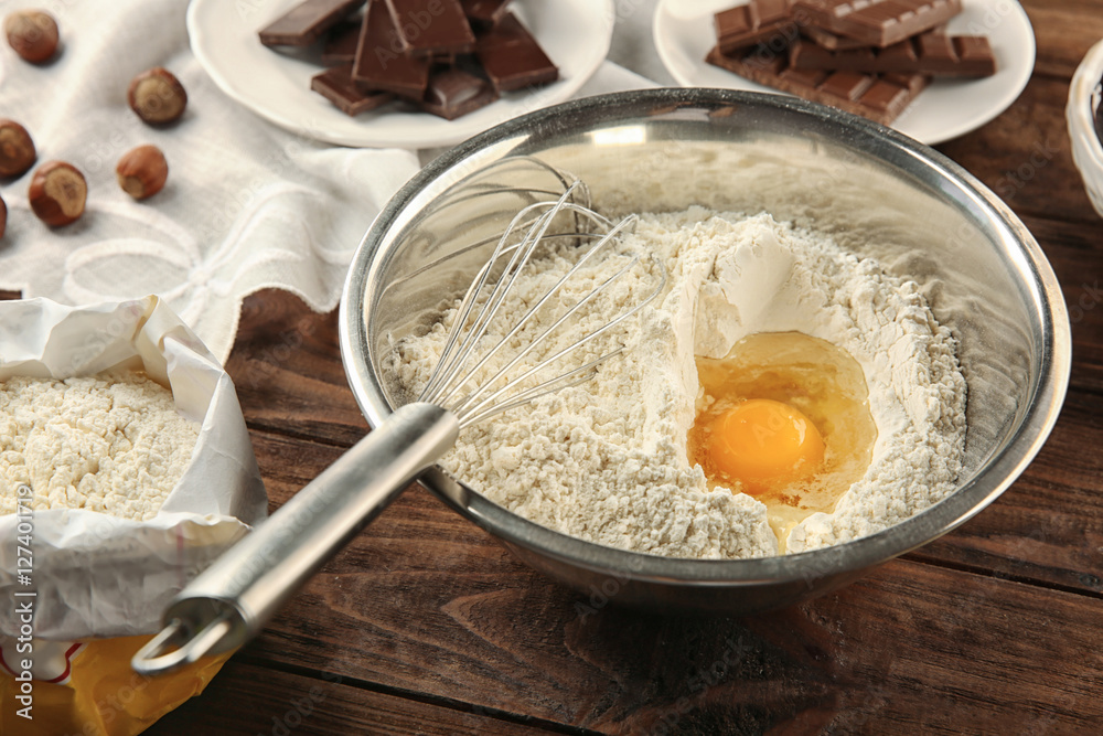 Ingredients for making chocolate cake on wooden background