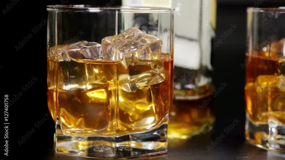 glasses of malt whiskey on a wooden table. video dolly glasses of malt whiskey on a wooden table. video dolly