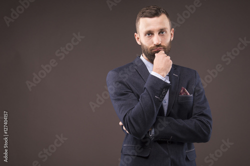 Confident man leaned his hand to his beard