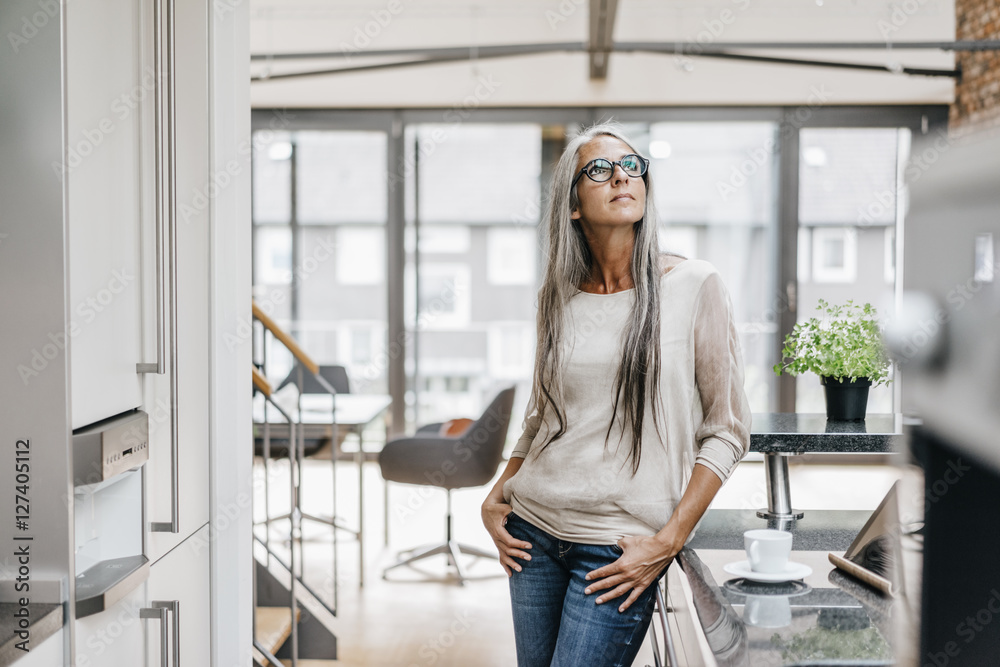 Woman with long grey hair standing in office Woman with long grey hair standing in office