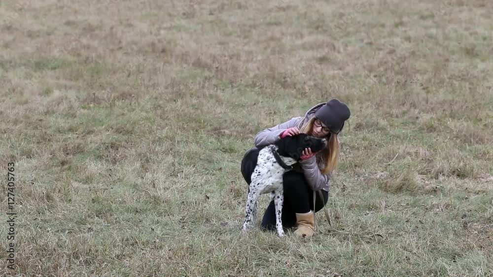 Teenage girl walking the dog on cloudy autumn day. Teenage girl walking the dog on cloudy autumn day.