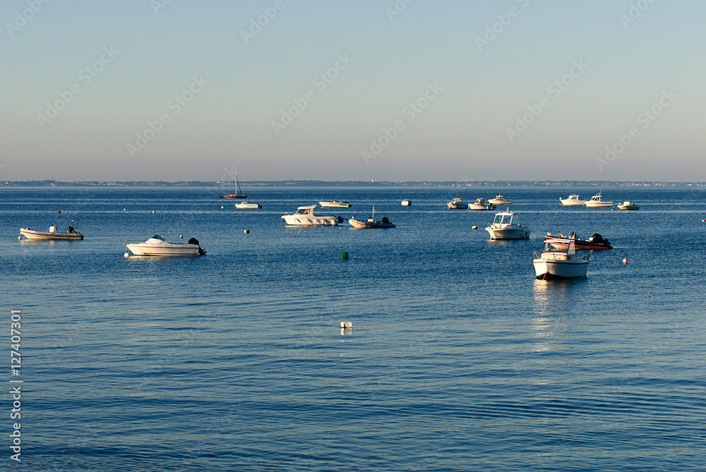 boats parked on water in the morning waiting for their owner to part with them on the seq