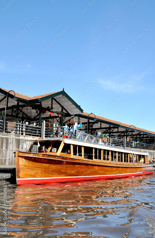 TIGRE, BUENOS AIRES, ARGENTINA - NOVEMBER 2016: Closeup of a typical wooden old water taxi motorboat in the port of the popular riverside resort El Tigre at the Parana Delta.