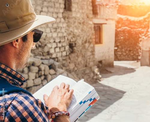 Εκτύπωση καμβά Close up image tourist with guide book on asian street