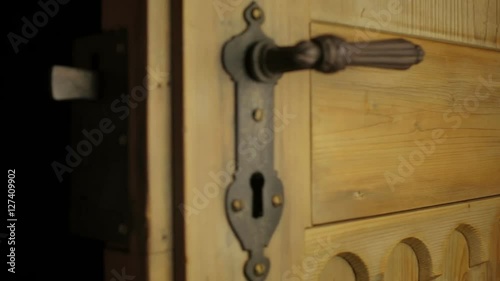 neutral color shot of a closing medieval wooden door