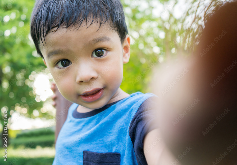 outdoor portrait of a little asian boy smiling with sunset. outdoor portrait of a little asian boy smiling with sunset.