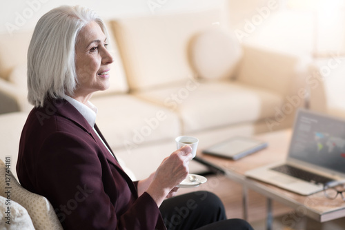 Peaceful businesswoman drinking coffee in the hotel