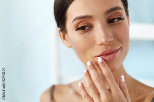 Photo Lips Skin Care. Woman With Beauty Face Applying Lip Balm On