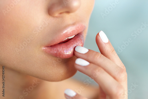Vászonkép Lips Protection. Closeup of Healthy Woman Lips And Smooth Skin