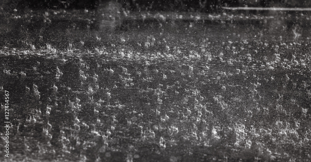 Obraz premium Rain on asphalt or tarmac road creating ripples