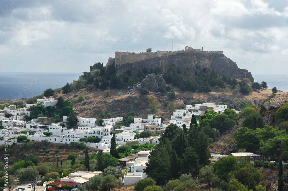 Lindos and acropolis of Lindos, Rhodes Island, Greece.  Lindos  is  town on the island of Rhodes, in the Dodecanese, Greece. Above the modern town rises the acropolis of Lindos.