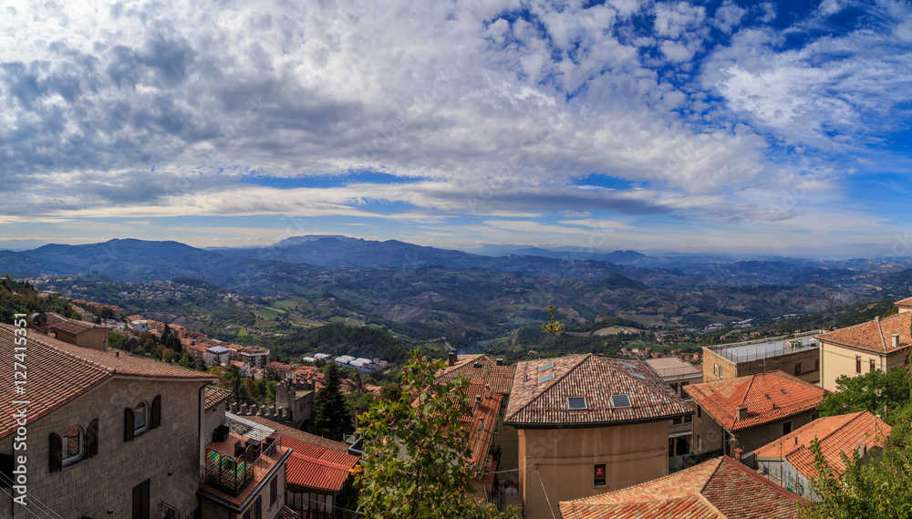 The view from the observation platform of Mount Titano, hills, clouds, a tiled roof