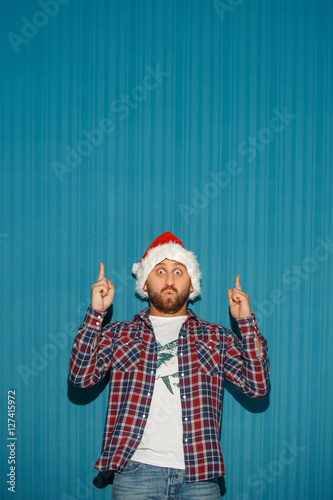 Surprised christmas man wearing a santa hat