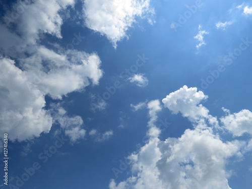 Sky with clouds. Beautiful blue natural background with white cloudy and sun.