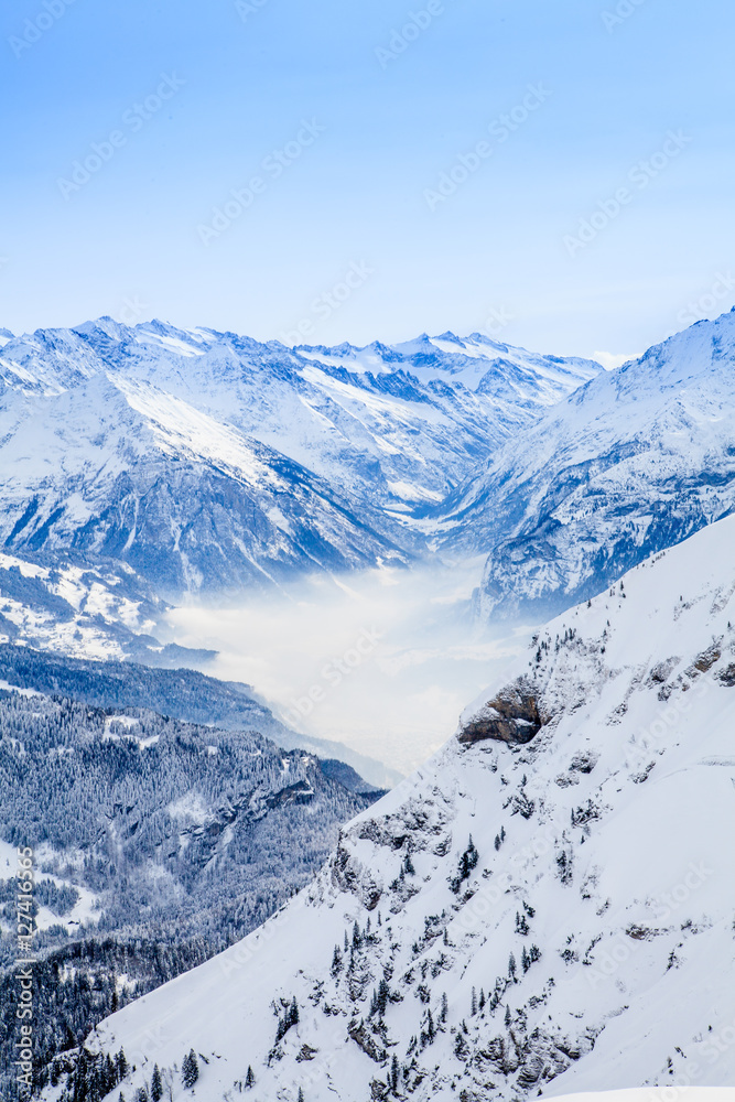 Winter snow covered mountain peaks in Europe. The Alps winter mo