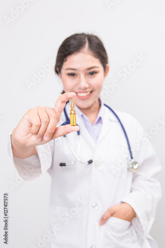 woman doctor holding drug ampule