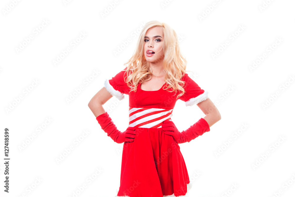 Beautiful blonde woman in a red New Year's costume standing on the white background