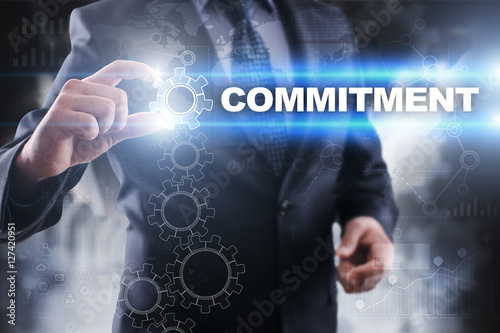 Businessman selecting commitment on virtual screen.