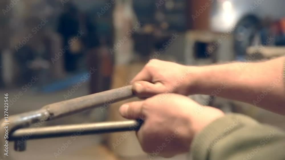 Close-up blacksmith shapes the metal manually Close-up blacksmith shapes the metal manually