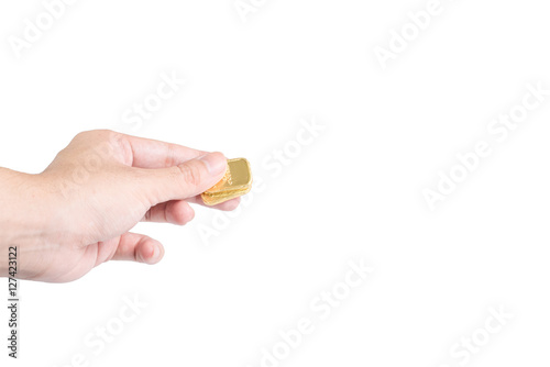 The chocolate gold coin  in hand on white background, clipping path