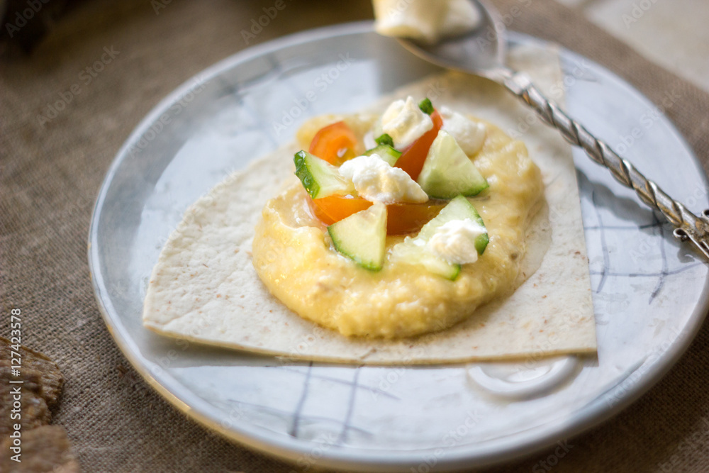 Shot of hummus - vegetarian dish from middle east. Hummus with tomatoes, cucumbers and cheese. Shot of hummus - vegetarian dish from middle east. Hummus with tomatoes, cucumbers and cheese.