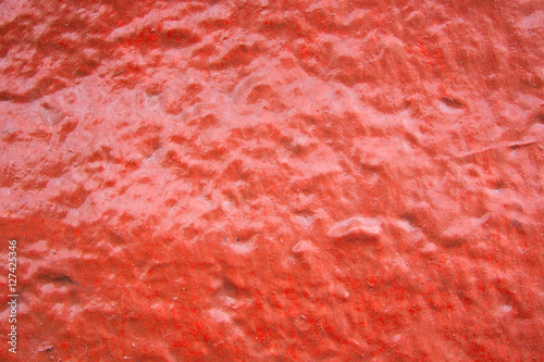 Rough orange painted on cement floor texture background