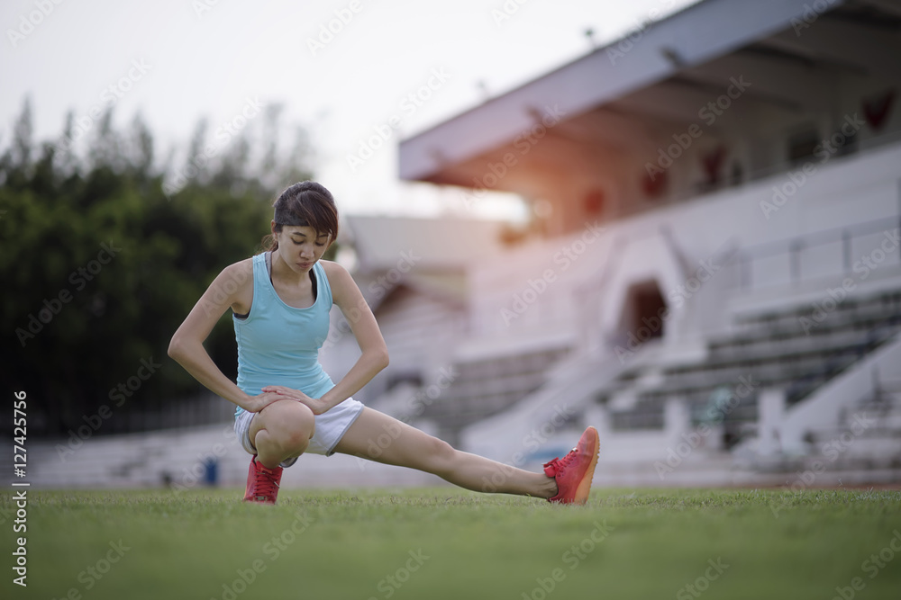 Woman is in action of  exercise and warm-up 