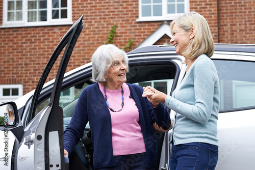 Female Neighbor Giving Senior Woman A Lift In Car photo